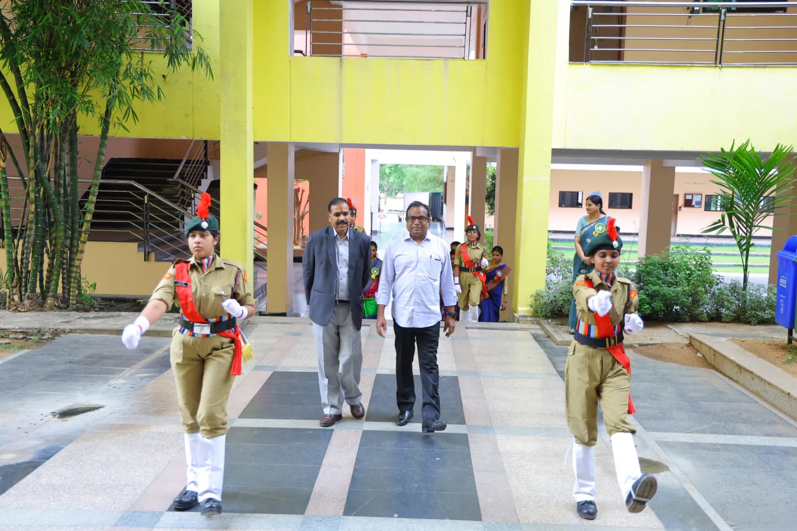 NCC cadets escorting faculty through the campus building