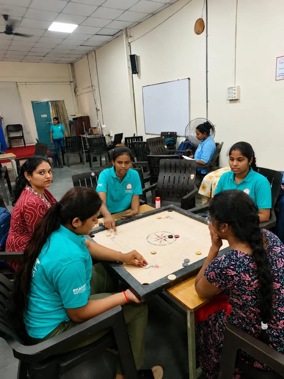 Students playing carrom in the campus common room