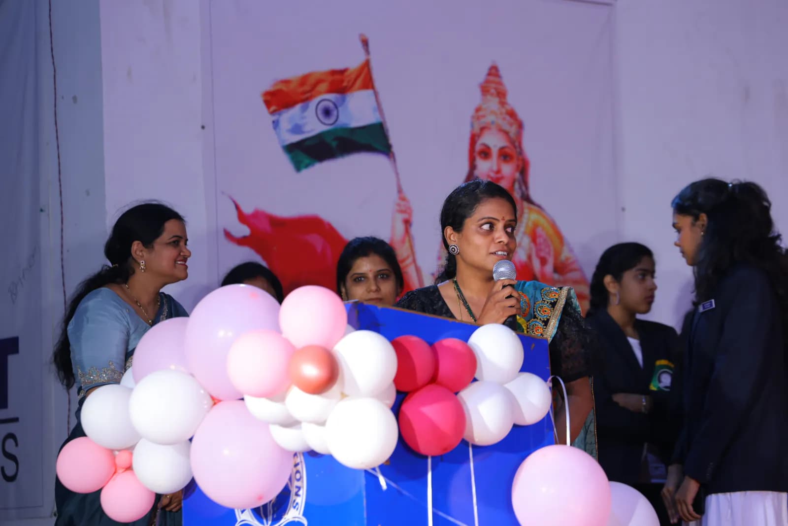 Faculty addressing students at a cultural event